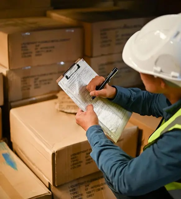 asian-male-warehouse-worker-checking-inventory-list-paper-working-warehouse